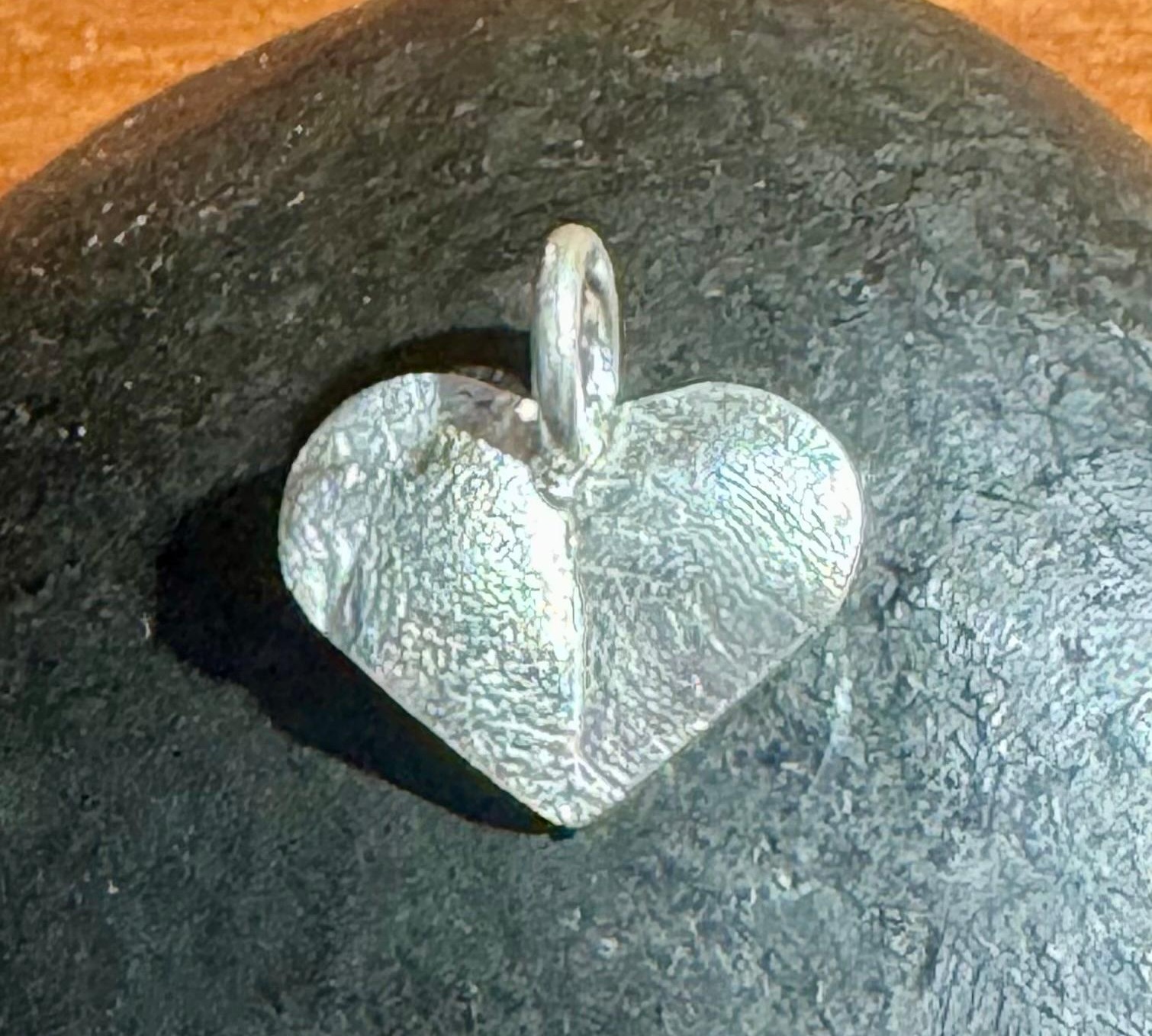 True-to-size silver nose and paw-print keepsakes on a table