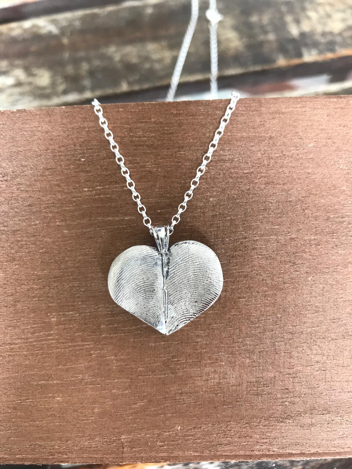 His and hers fingerprint heartshaped pendant